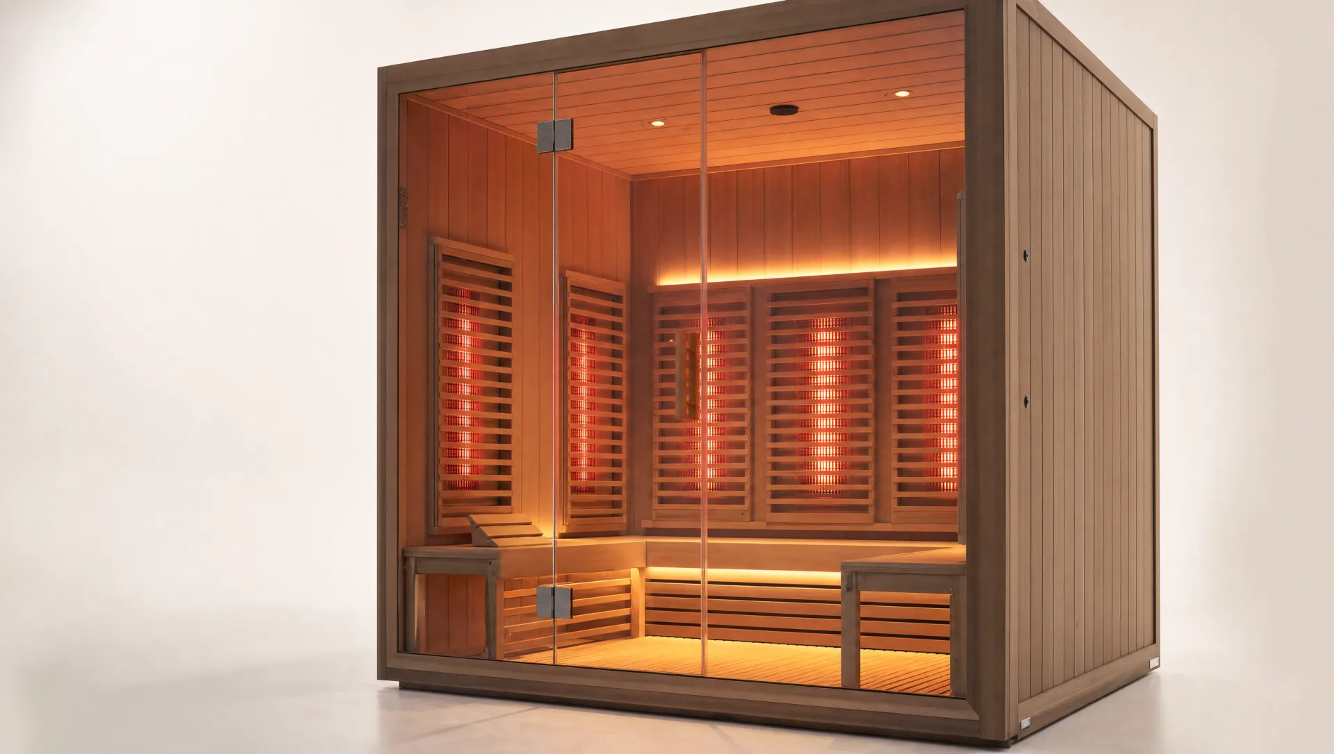An empty infrared sauna cabin with glowing red heater panels against a clean studio background